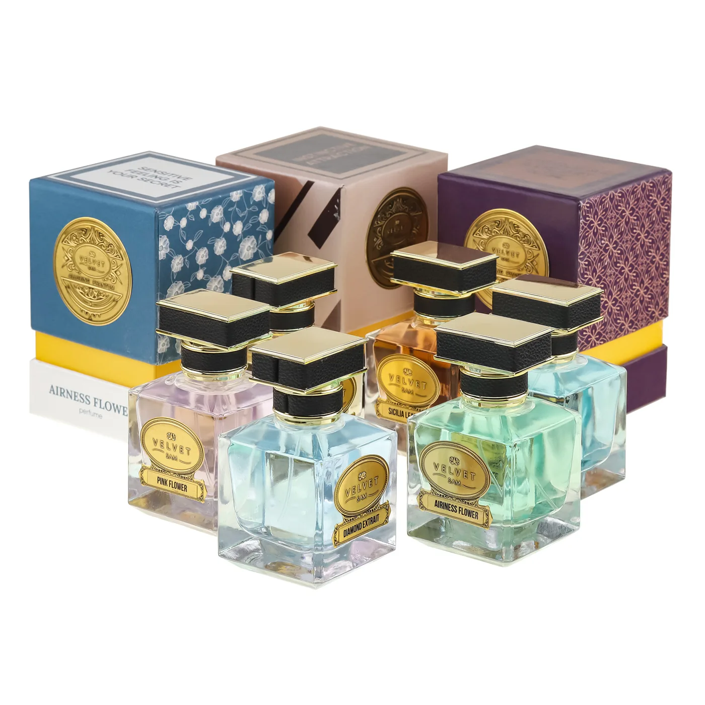Perfume Line flacons in pastel glass in front of their boxes